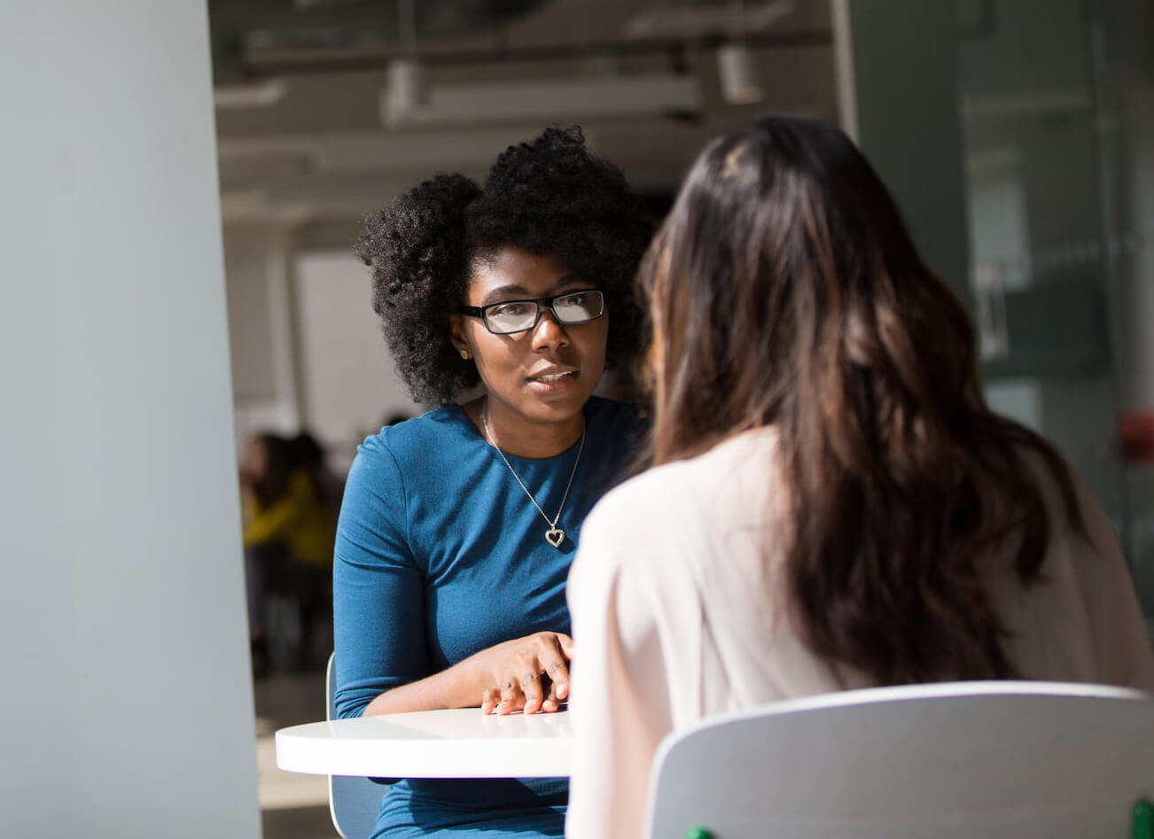 black woman in blue speaking to someone behavioral studies