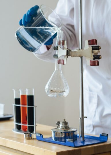 chemistry student uses beaker in tube