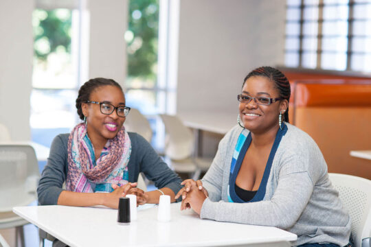 two students talking cafeteria dining services