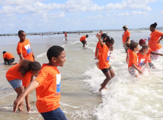 coast campers playing in ocean on tybee